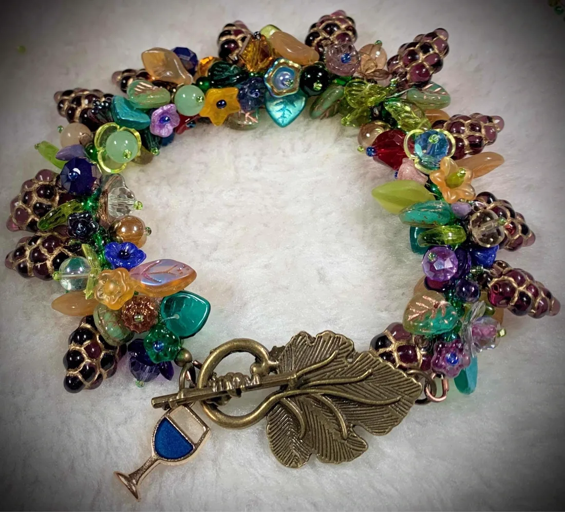 A chunky beaded vine bracelet with grape and leaf beads and a leaf toggle clasp
